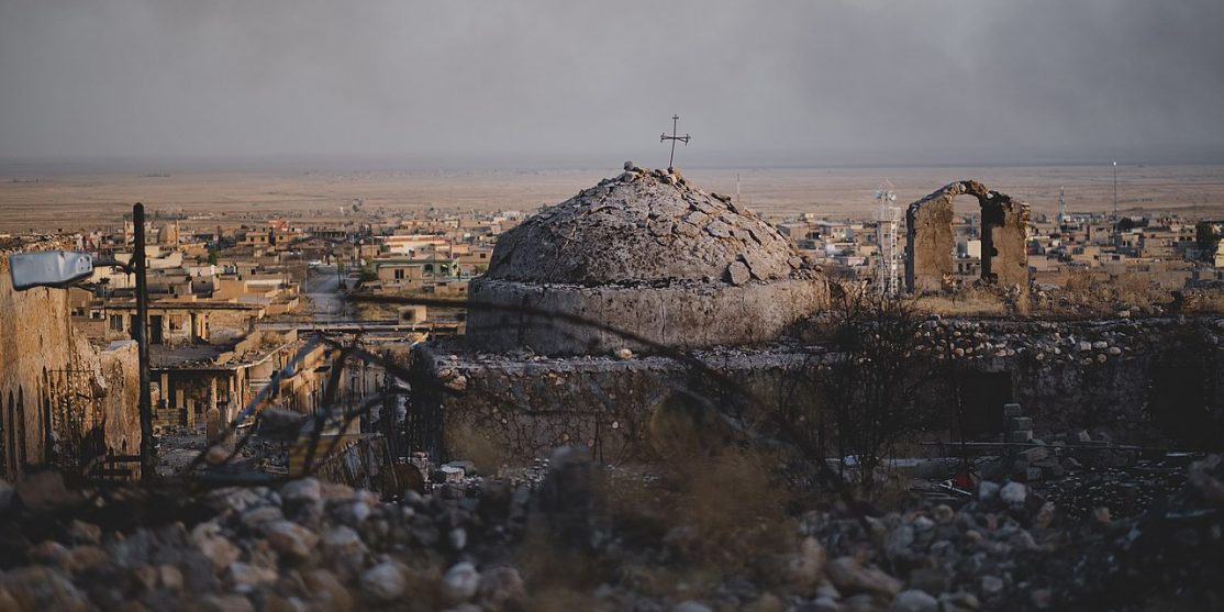 1280px-Views_in_June_of_2019_of_a_cathedral_rising_above_ruined_buildings_in_the_old_neighborhood_of_Shingal_(Sinjar)_18